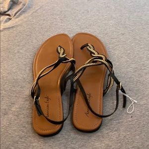 Black sandals with gold